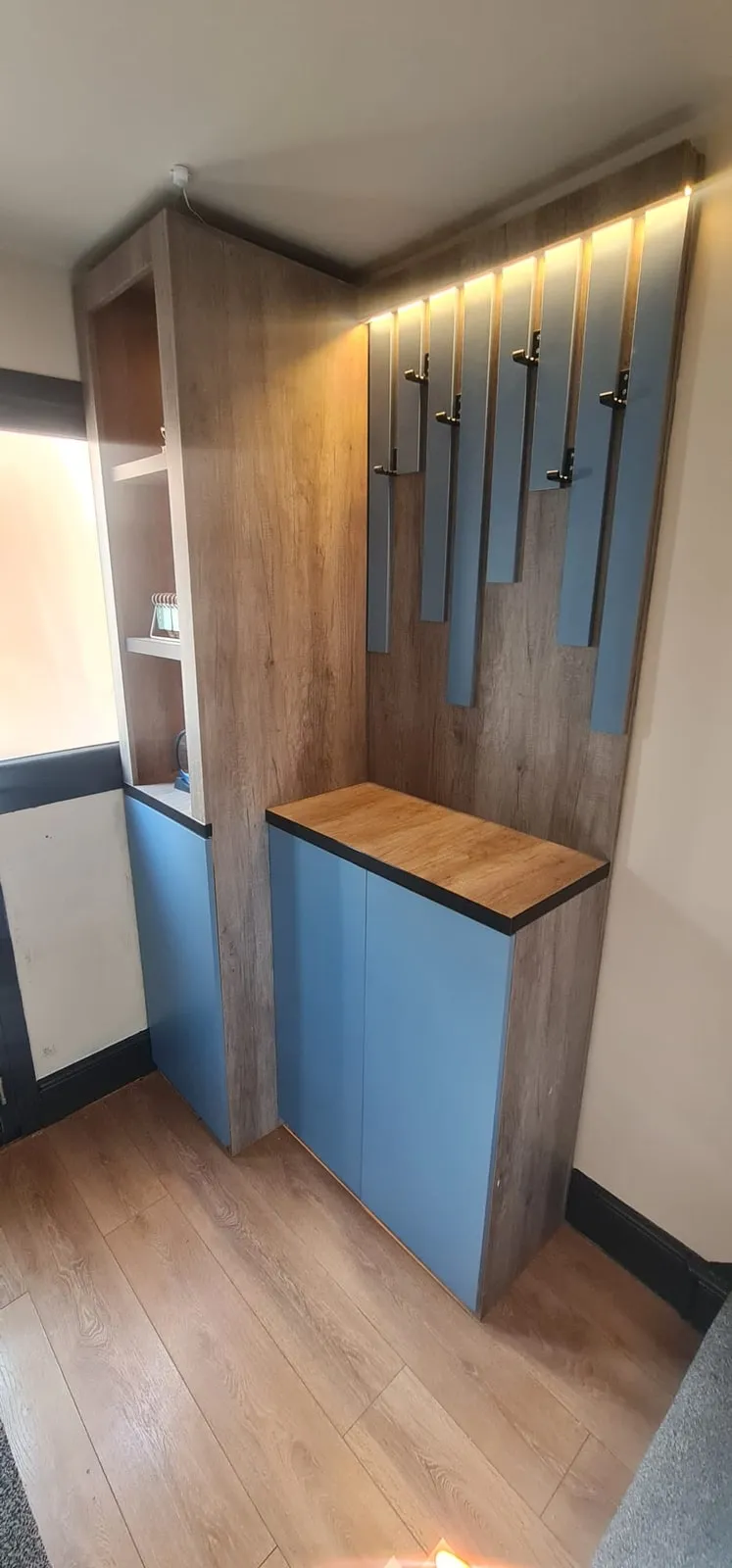 Hallway unit with a blue shoe cabinet, oak top and vertical coat panels